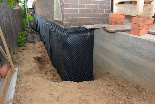 SJ Waterproofing Pros technician performing targeted Emergency Waterproofing assessment in Docena, AL